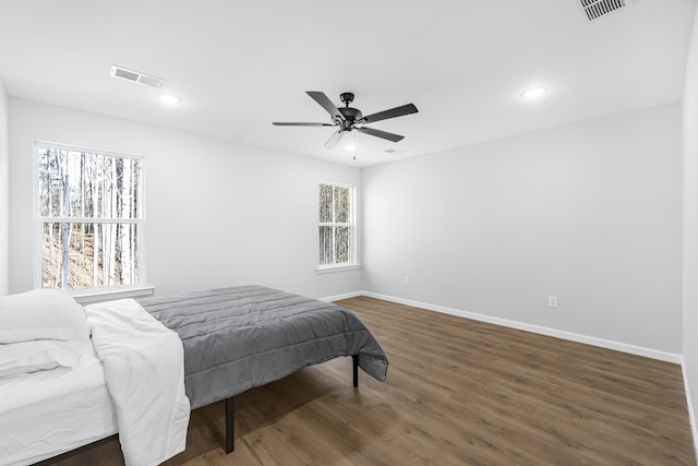 bedroom with dark wood-type flooring and ceiling fan