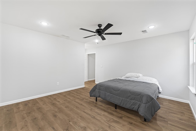 bedroom with dark wood-type flooring and ceiling fan