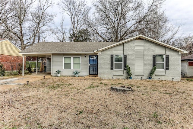 ranch-style home with a carport and a front lawn