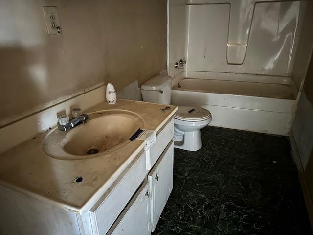 full bathroom with vanity, bathtub / shower combination, and toilet