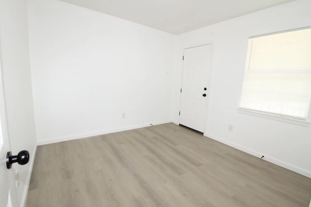 spare room with light wood-type flooring