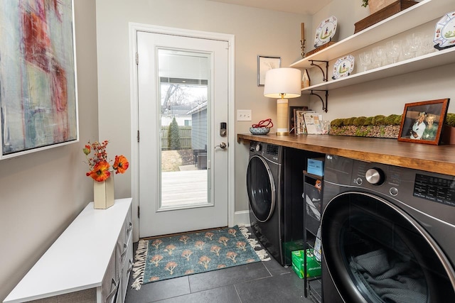 laundry room with dark tile patterned floors, separate washer and dryer, and a healthy amount of sunlight