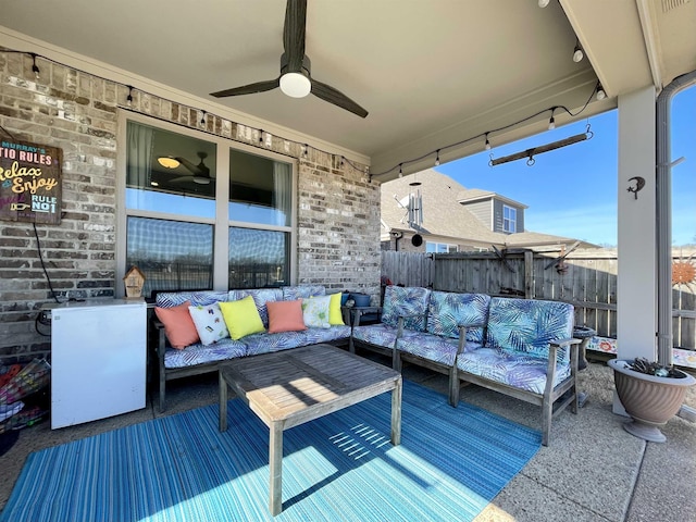 wooden deck with an outdoor hangout area, a patio, and ceiling fan