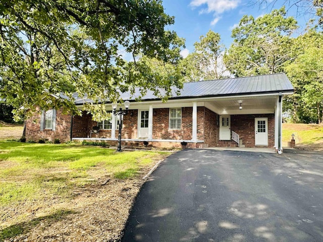 single story home featuring a carport and a front yard