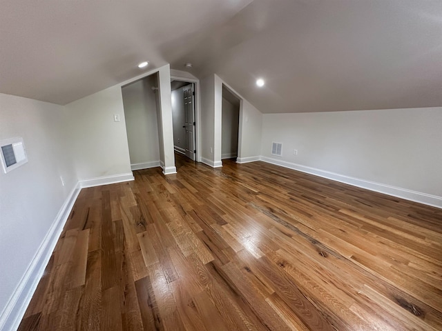 bonus room featuring vaulted ceiling and wood-type flooring