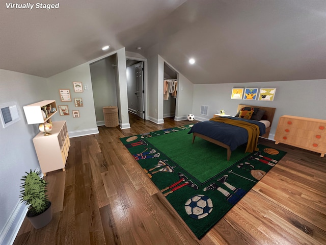 bedroom featuring dark wood-type flooring and vaulted ceiling