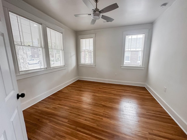 spare room featuring ceiling fan and dark hardwood / wood-style floors