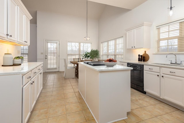 kitchen featuring sink, a kitchen island, white cabinets, and dishwasher