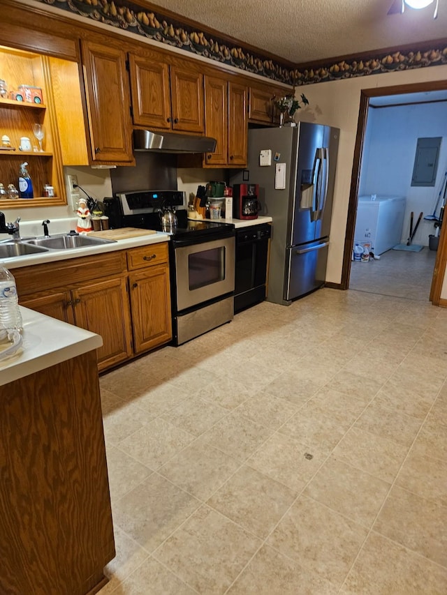 kitchen featuring sink, appliances with stainless steel finishes, electric panel, and a textured ceiling