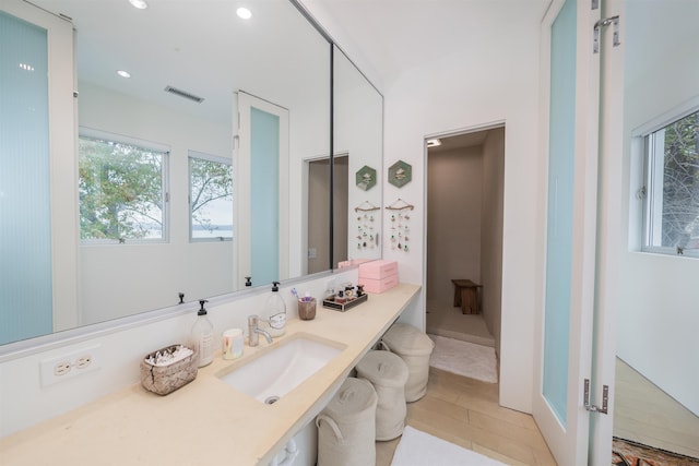 bathroom with hardwood / wood-style floors, a wealth of natural light, and vanity