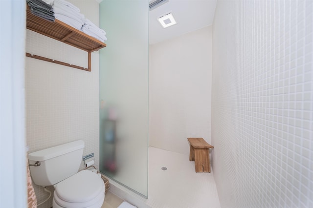 bathroom with toilet and a shower