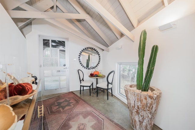 entryway with concrete flooring and vaulted ceiling with beams