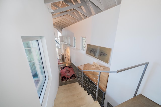 stairs with lofted ceiling with beams and wood ceiling