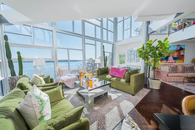 sunroom with a water view and a healthy amount of sunlight