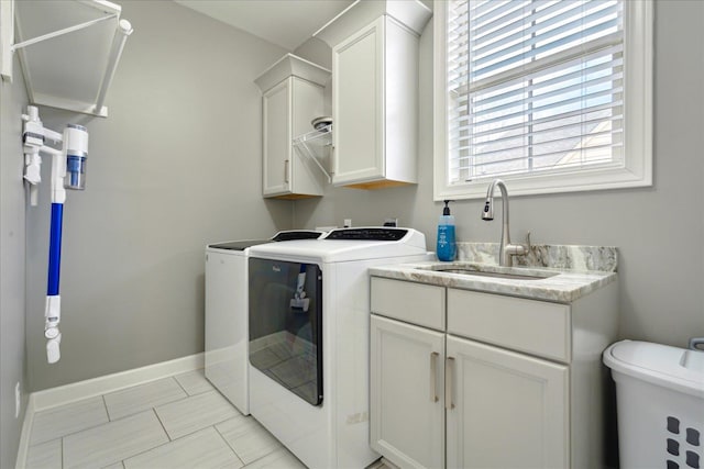 washroom with washer and dryer and sink