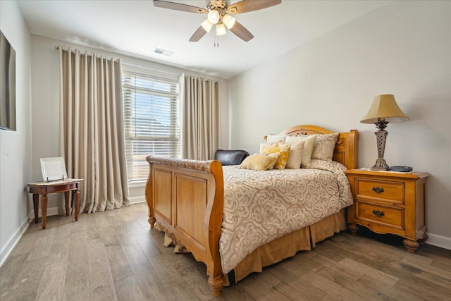 bedroom with ceiling fan and wood-type flooring