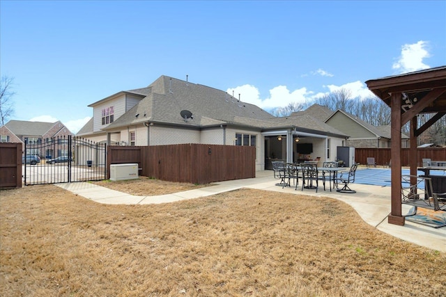 rear view of house featuring a yard and a patio area