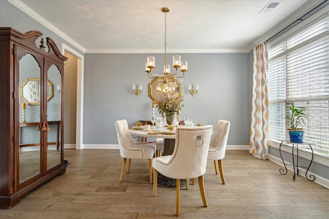 dining area with a notable chandelier, light hardwood / wood-style flooring, and crown molding