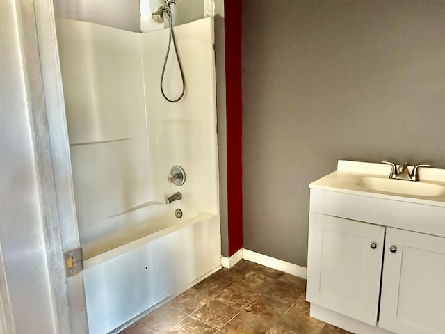 bathroom featuring washtub / shower combination, vanity, and tile patterned flooring