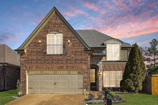 front facade featuring a garage and a lawn