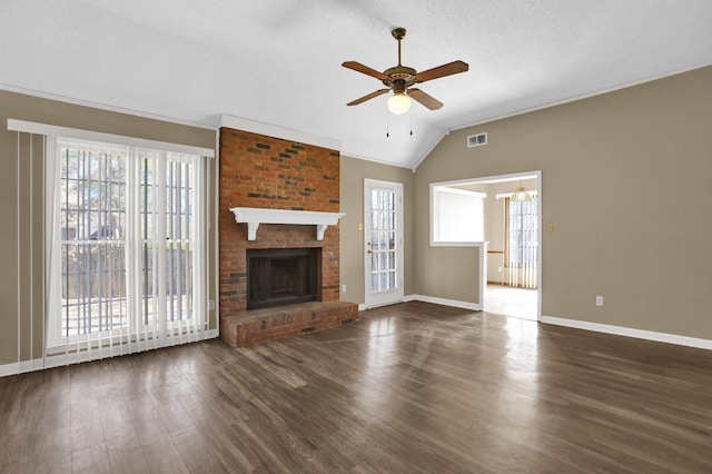 unfurnished living room featuring vaulted ceiling, dark hardwood / wood-style floors, and a healthy amount of sunlight