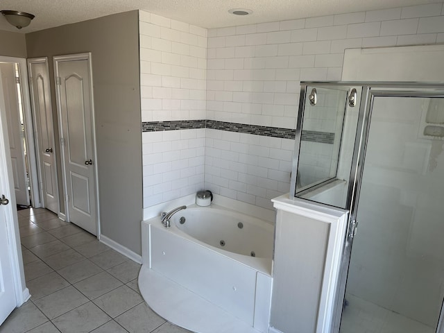 full bathroom with a textured ceiling, a whirlpool tub, a shower stall, and tile patterned floors