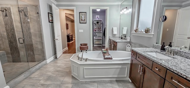 bathroom featuring tile patterned floors, vanity, crown molding, and independent shower and bath