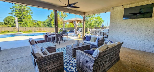 view of patio / terrace with ceiling fan, an outdoor hangout area, and a fenced in pool