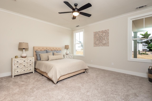 carpeted bedroom with ceiling fan and crown molding