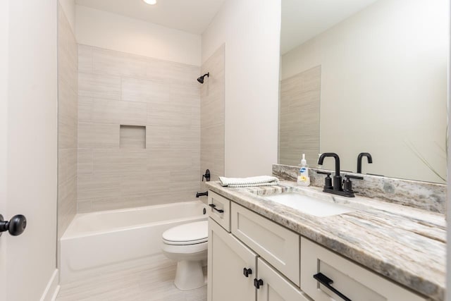 full bathroom with toilet, vanity, and tiled shower / bath combo