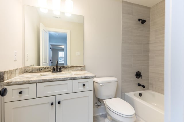 full bathroom featuring tiled shower / bath combo, vanity, and toilet