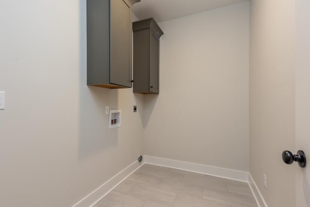 washroom featuring cabinets, washer hookup, and electric dryer hookup