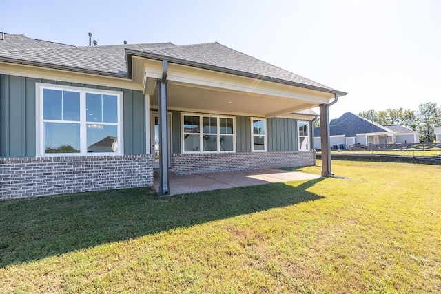 rear view of house with a patio area and a yard