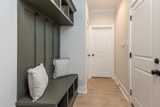 mudroom with light wood-type flooring and ornamental molding