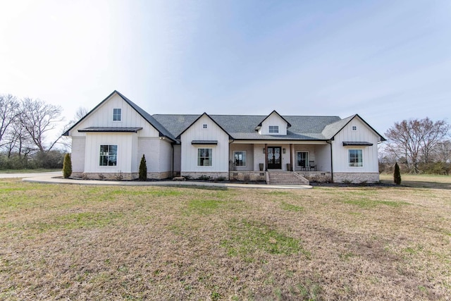 modern inspired farmhouse featuring a front lawn and a porch