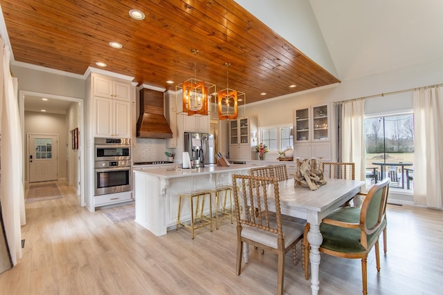 dining area with ornamental molding, light hardwood / wood-style flooring, wood ceiling, and a notable chandelier