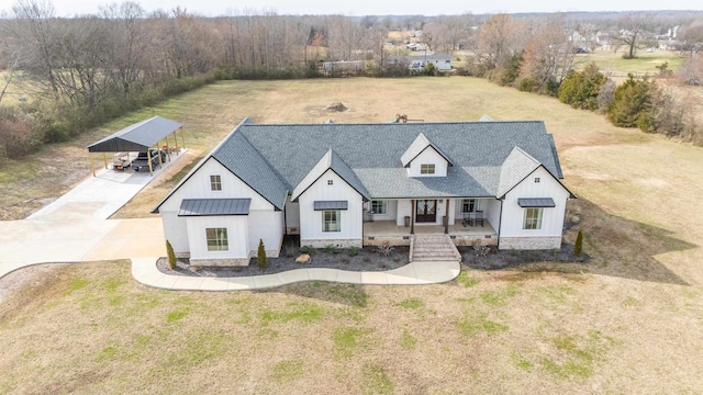 modern farmhouse style home with a front lawn, a carport, and a porch