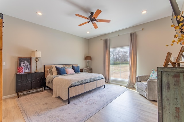 bedroom featuring ceiling fan and light hardwood / wood-style flooring