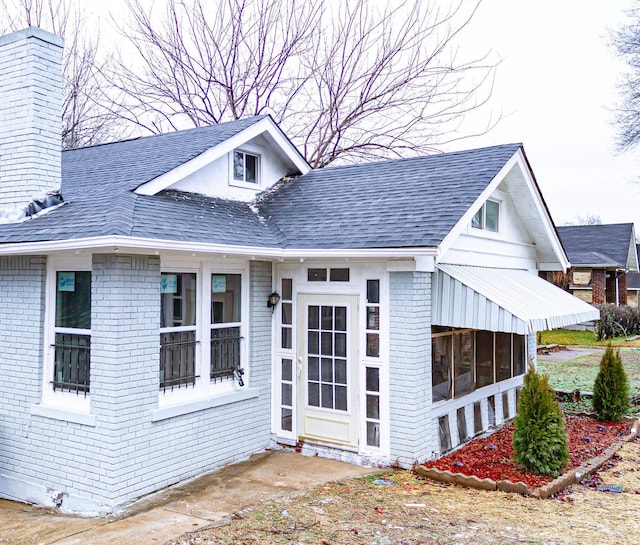 view of front of house featuring a sunroom