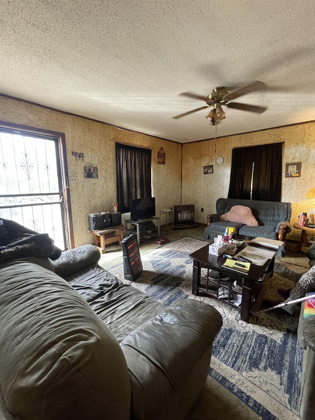 living room featuring ceiling fan and a textured ceiling