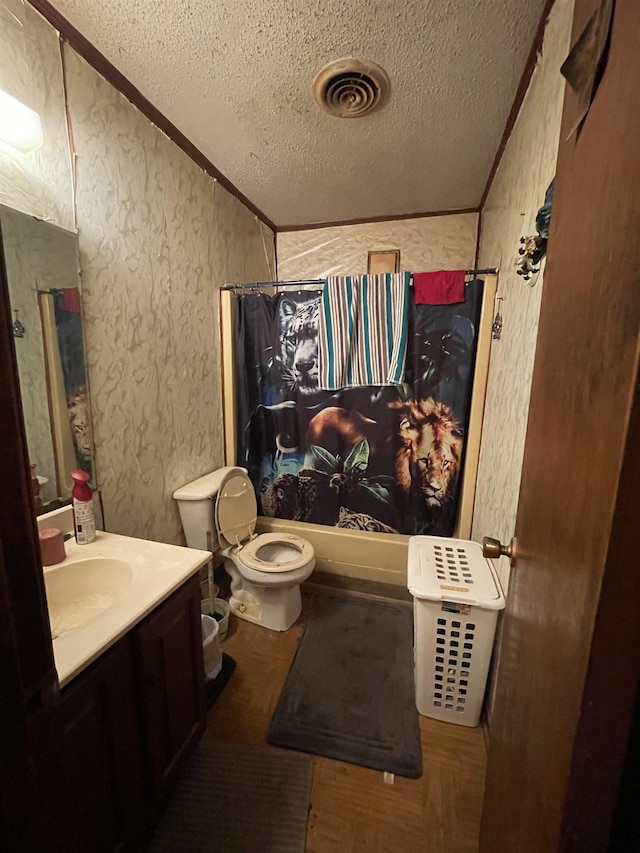 full bathroom featuring wood-type flooring, shower / tub combo, a textured ceiling, crown molding, and vanity