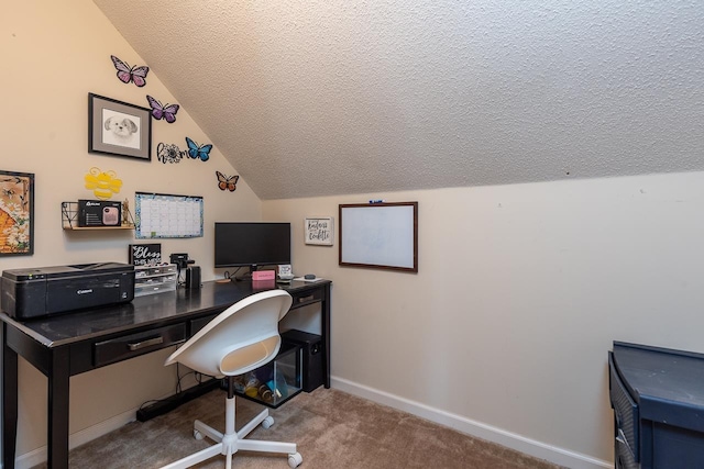 carpeted office featuring vaulted ceiling and a textured ceiling