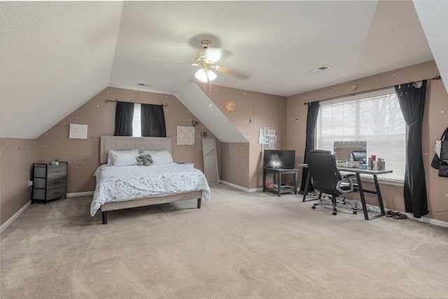 carpeted bedroom featuring lofted ceiling, ceiling fan, and a textured ceiling