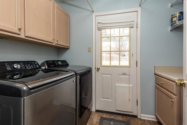 washroom with washer and dryer, cabinets, and dark hardwood / wood-style flooring