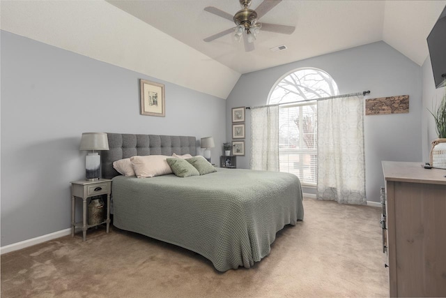 carpeted bedroom with vaulted ceiling and ceiling fan