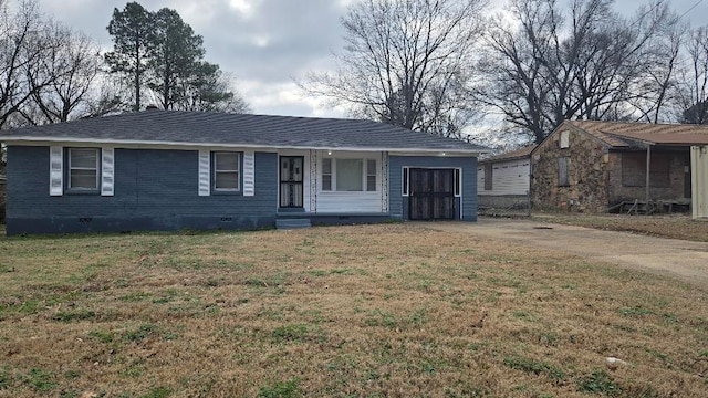 view of front of property featuring roof with shingles, brick siding, crawl space, and a front yard