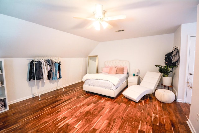 bedroom with ceiling fan, dark wood-type flooring, and vaulted ceiling