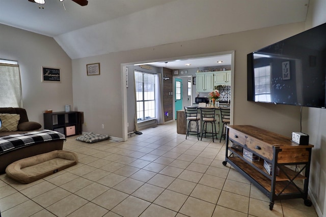 tiled living room featuring vaulted ceiling and ceiling fan