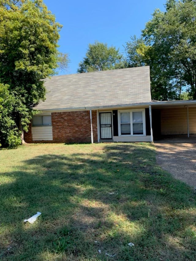 ranch-style house with a carport and a front lawn