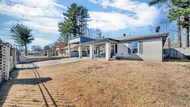 rear view of house featuring a lawn